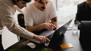 Resources 7 a man pointing at a laptop